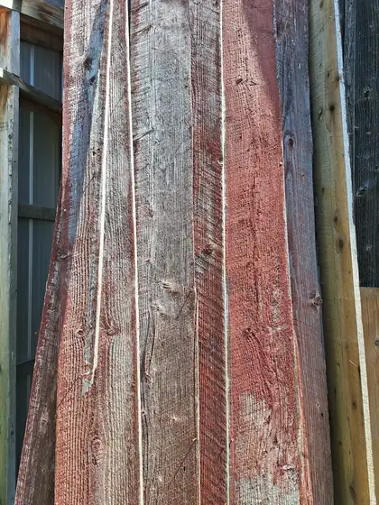 Close view of weathered red barn boards